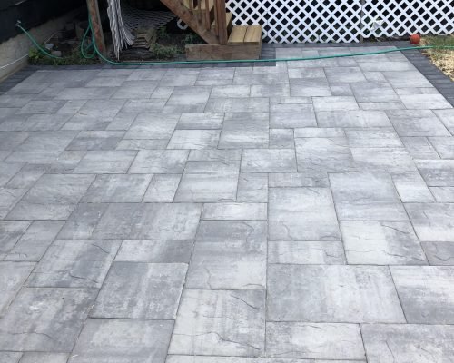 Paver patio construction in Armonk, NY with durable and decorative materials